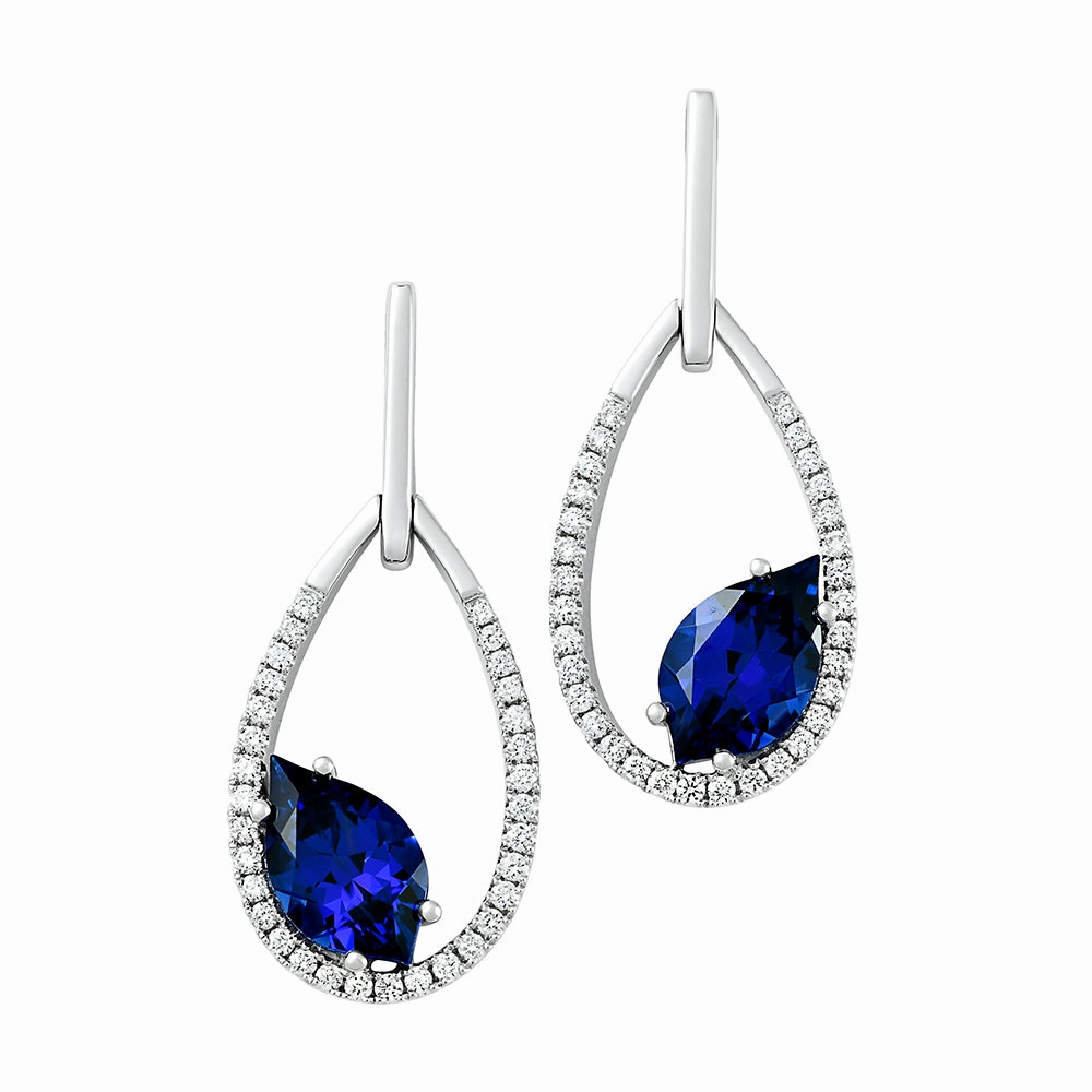 Elegant Feel 14K white gold earrings featuring 10x6mm flame cut Chatham lab grown sapphire with Chatham lab grown diamond accents.