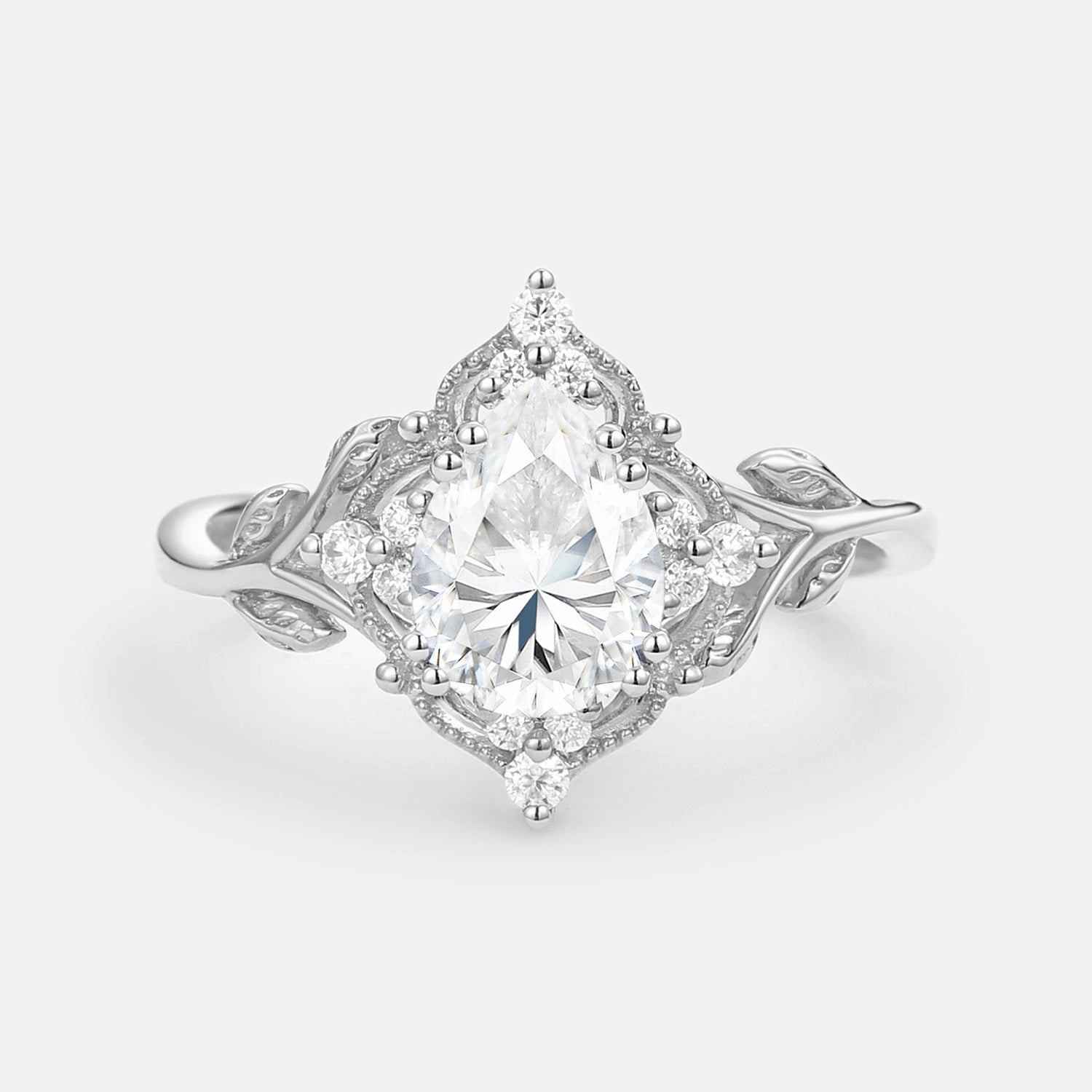 Camera Mood Luxe Look Pear Cut Moissanite Leafy Vintage Engagement Ring